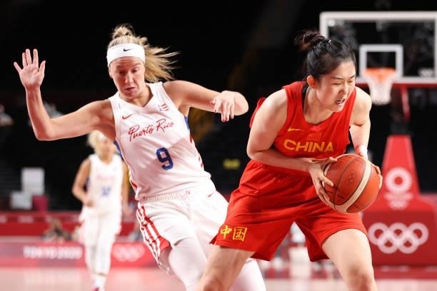 Zhenqi Pan of Team China fights for possession of the ball with Ali Gibson of Team Puerto Rico during the first half of a Women's Preliminary Round...