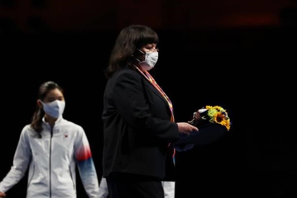 Exexcutive Committee Member Erika Aze takes part in the Women's Epée Team Victory Ceremony on day four of the Tokyo 2020 Olympic Games at Makuhari...