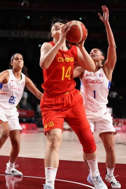 Yueru Li of Team China drives to the basket against Tayra Melendez of Team Puerto Rico during the second half of a Women's Preliminary Round Group C...