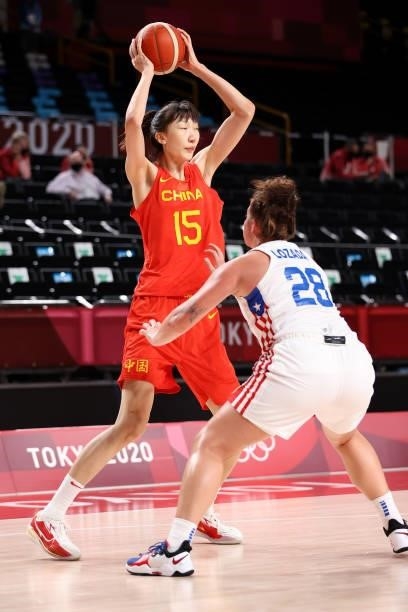 Xu Han of Team China looks to pass as she's defended by Sabrina Lozada-Cabbage of Team Puerto Rico during the second half of a Women's Preliminary...