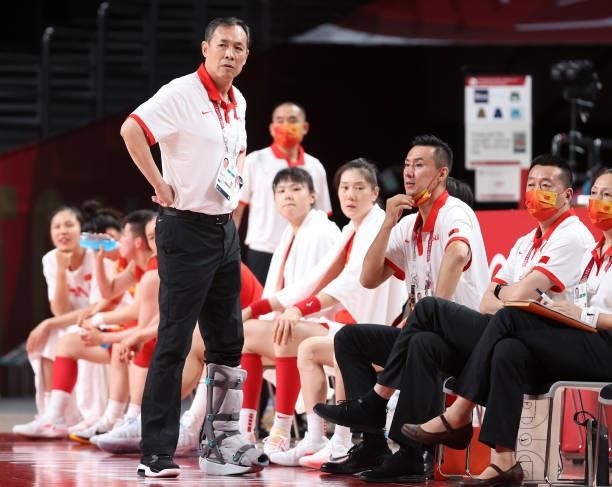 Head Coahc of Team China Xu Limin speaks with his coaching staff during the second half of their Women's Preliminary Round Group C game against...