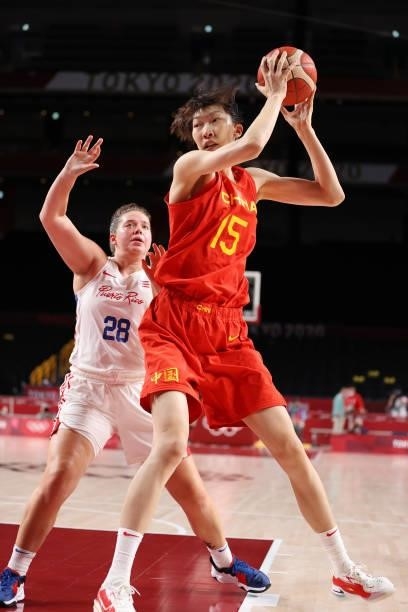 Xu Han of Team China drives to the basket against Sabrina Lozada-Cabbage of Team Puerto Rico during the second half of a Women's Preliminary Round...