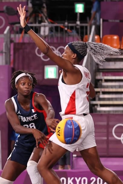 Mamignan Toure of Team France passes around Stephanie Mawuli of Team Japan in the 3x3 Basketball competition on day four of the Tokyo 2020 Olympic...