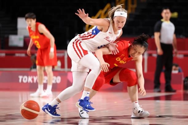 Ali Gibson of Team Puerto Rico and Ting Shao of Team China battle for possession of a loose ball during the second half of a Women's Preliminary...