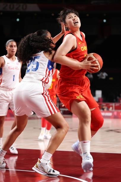 Yueru Li of Team China drives to the basket against Isalys Quinones of Team Puerto Rico during the second half of a Women's Preliminary Round Group C...