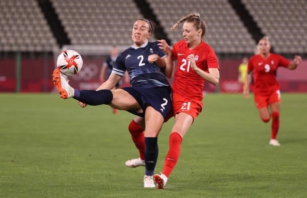 Lucy Bronze of Team Great Britain controls the ball whilst under pressure from Gabrielle Carle of Team Canada during the Women's Group E match...