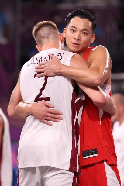 Tomoya Ochiai of Team Japan and Karlis Lasmanis of Team Latvia react after the game in the 3x3 Basketball competition on day four of the Tokyo 2020...