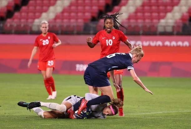 Stephanie Labbe of Team Canada collects the ball whilst under pressure from Sophie Ingle of Team Great Britain during the Women's Group E match...