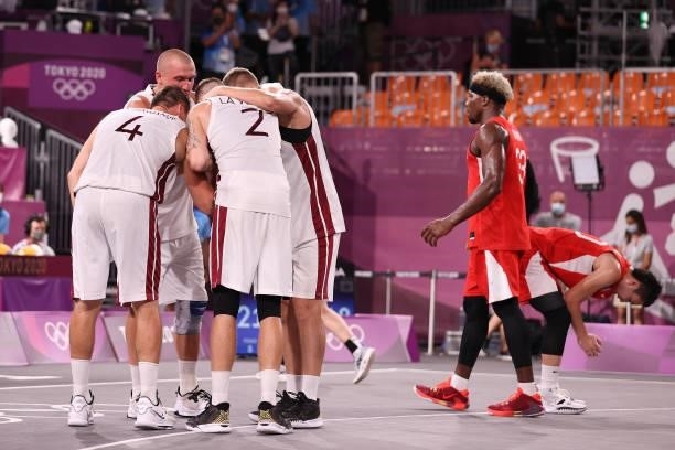 Team Latvia celebrates victory as Team Japan reacts in the 3x3 Basketball competition on day four of the Tokyo 2020 Olympic Games at Aomi Urban...