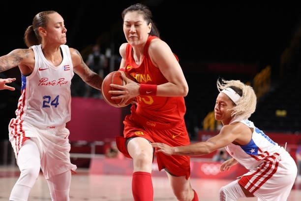 Mengran Sun of Team China splits defenders Jazmon Gwathmey and Dayshalee Salaman of Team Puerto Rico as she drives to the basket during the second...