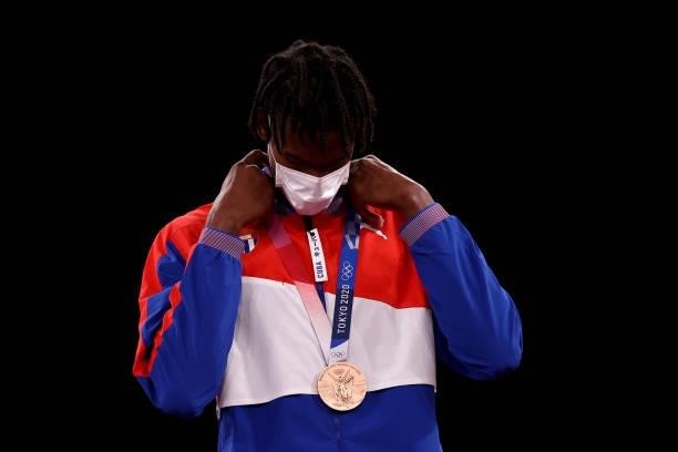 Bronze medalist Rafael Yunier Alba Castillo of Team Cuba adjusts his medal for the Men's +80kg Taekwondo on day four of the Tokyo 2020 Olympic Games...