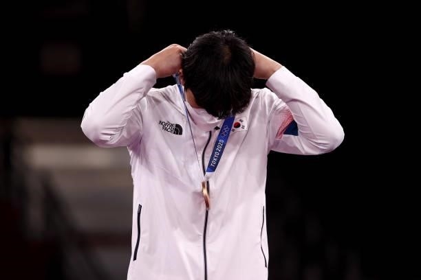 Bronze medalist In Kyo-don of Team South Korea adjusts his medal for the Men's +80kg Taekwondo on day four of the Tokyo 2020 Olympic Games at...