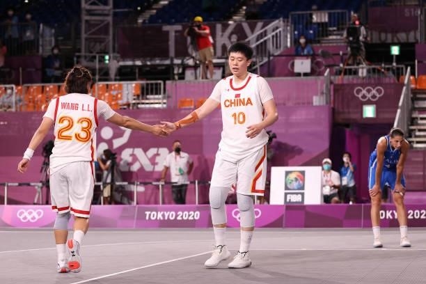 Zhiting Zhang of Team China celebrates with Lili Wang of Team China in the 3x3 Basketball competition on day four of the Tokyo 2020 Olympic Games at...