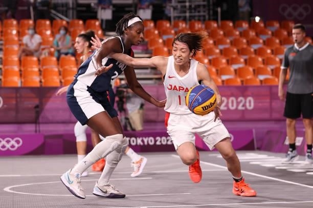 Mio Shinozaki of Team Japan handles the ball against Mamignan Toure of Team France in the 3x3 Basketball competition on day four of the Tokyo 2020...
