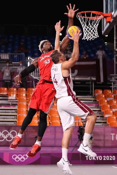 Agnis Cavars of Team Latvia drives to the basket under pressure from Ira Brown of Team Japan in the 3x3 Basketball competition on day four of the...