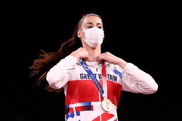 Bronze medalist Bianca Walkden of Team Great Britain adjusts her medal for the Women's +67kg Taekwondo on day four of the Tokyo 2020 Olympic Games at...