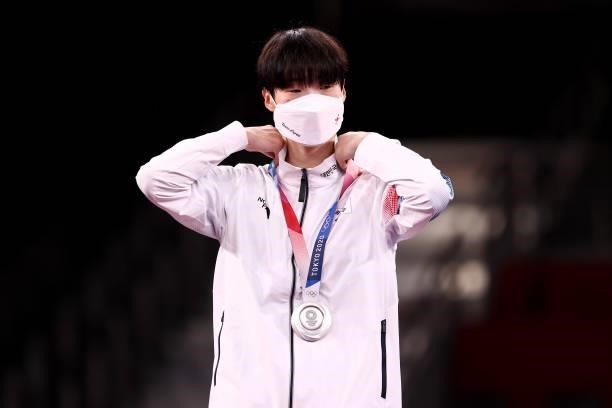 Silver medalist Lee Da-bin of Team South Korea adjusts her medal for the Women's +67kg Taekwondo on day four of the Tokyo 2020 Olympic Games at...