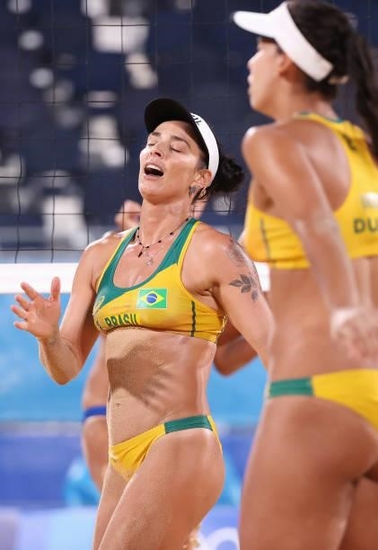 Agatha Bednarczuk and Eduarda Santos Lisboa of Team Brazil react against Team China during the Women's Preliminary - Pool C beach volleyball on day...