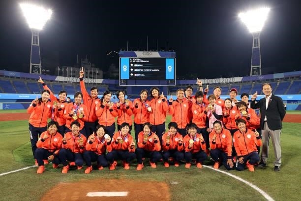 Team Japan poses for a team photo with their gold medals after defeating Team United States 2-0 in the Softball Gold Medal Game between Team Japan...