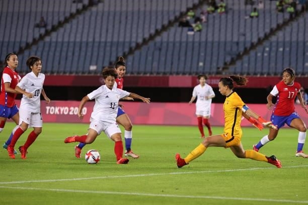 Mina Tanaka of Team Japan scores their side's first goal during the Women's Group E match between Chile and Japan on day four of the Tokyo 2020...