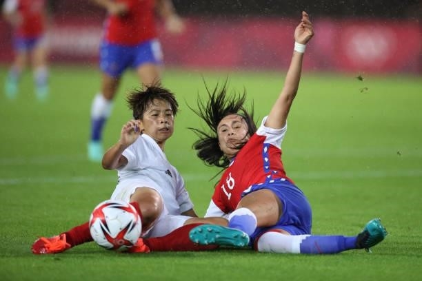 Mina Tanaka of Team Japan and Saez Camila of Team battle for the ball Chile during the Women's Group E match between Chile and Japan on day four of...