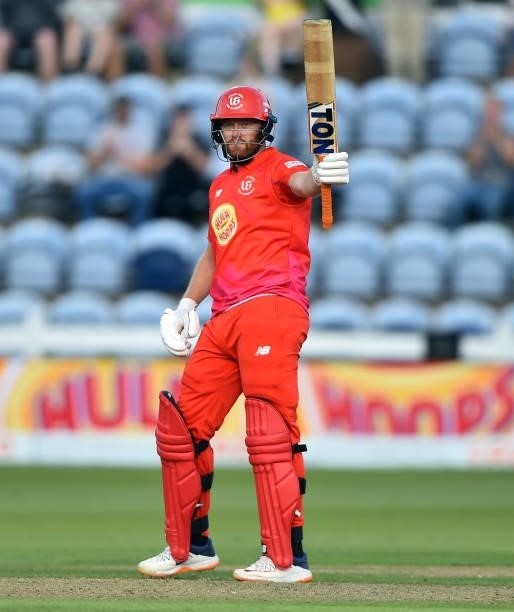 Jonny Bairstow of Welsh Fire raises his bat after scoring 50 runs during The Hundred match between Welsh Fire Men and Southern Brave Men at Sophia...