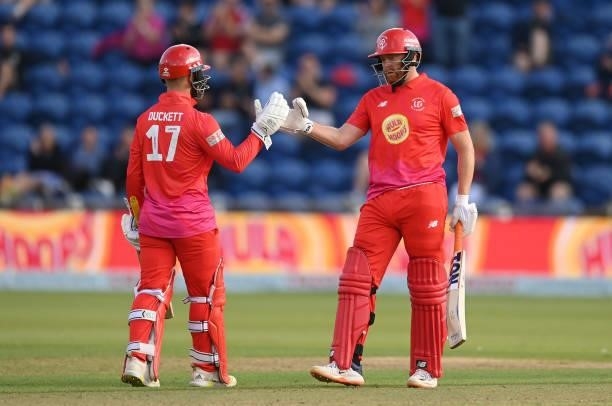 Jonny Bairstow and Ben Duckett of Welsh Fire punch gloves during The Hundred match between Welsh Fire and Southern Brave at Sophia Gardens on July...