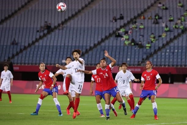 Yuika Sugasawa of Team Japan heads the ball with Daniela Pardo of Team Chile during the Women's Group E match between Chile and Japan on day four of...
