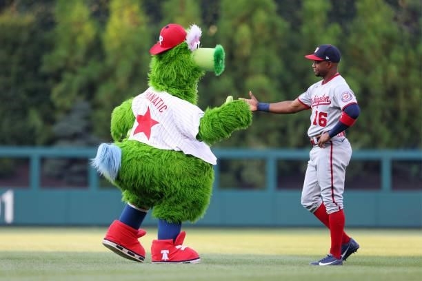 The Phillie Phanatic shakes hands with Victor Robles of the Washington Nationals before a game against the Philadelphia Phillies at Citizens Bank...
