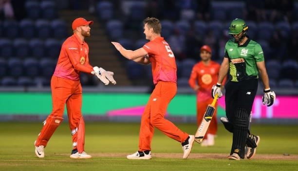 James Neesham of Welsh Fire celebrates with Jonny Bairstow after getting Ross Whiteley of Southern Brave out during The Hundred match between Welsh...