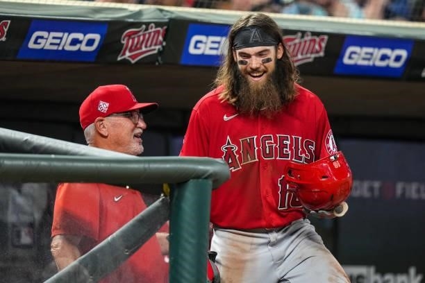 Brandon Marsh of the Los Angeles Angels talks with manager Joe Maddon against the Minnesota Twins on July 23, 2021 at Target Field in Minneapolis,...
