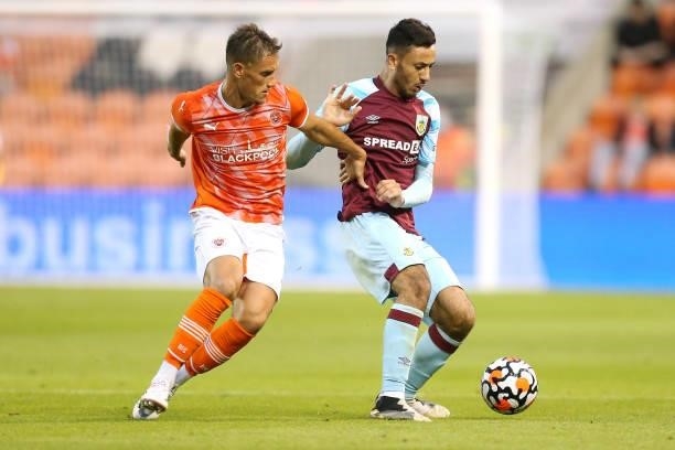 Dwight McNeil of Burnley battles for possession with Jerry Yates of Blackpool during the Pre-Season Friendly match between Blackpool and Burnley at...