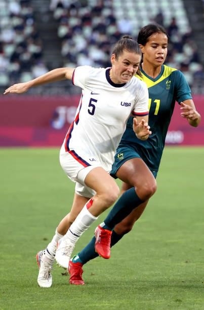 Kelley O'Hara of Team United States plays against Mary Fowler of Team Australia during the Women's Football Group G match on day four of the Tokyo...