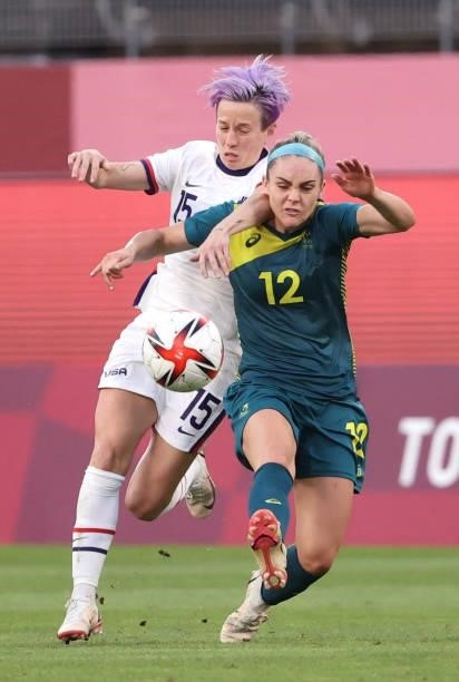 Megan Rapinoe of Team United States battles with Ellie Carpenter of Team Australia during the Women's Football Group G match on day four of the Tokyo...