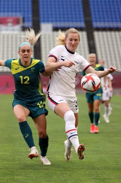 Samantha Mewis of Team United States plays against Ellie Carpenter of Team Australia during the Women's Football Group G match on day four of the...