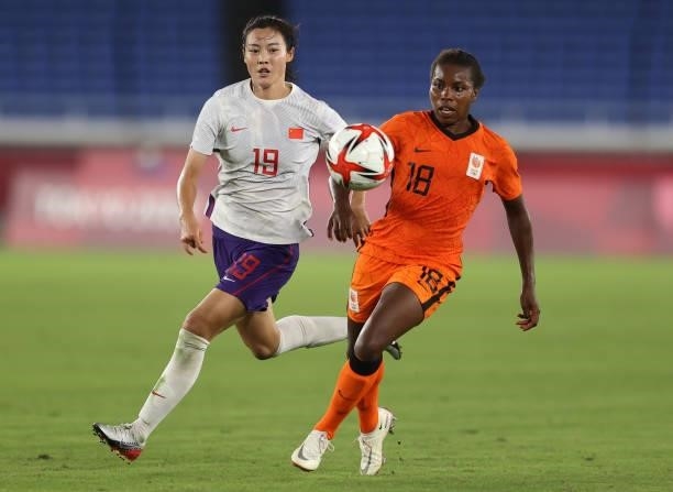Lineth Beerensteyn of Team Netherlands competes for the ball with Wang Ting#19 of Team China during the Women's Group F match between China and...
