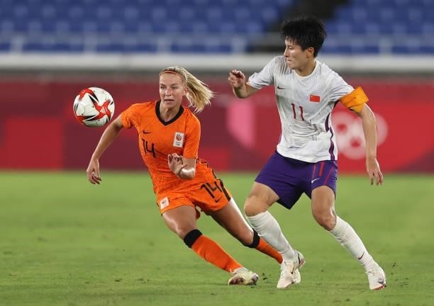 Jackie Groenen of Team Netherlands competes for the ball with Shanshan Wang#11 of Team China during the Women's Group F match between Netherlands and...