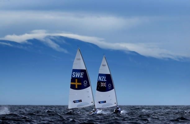Jesper Stalheim of Team Sweden and Sam Meech of Team New Zealand compete in Men's Laser race on day four of the Tokyo 2020 Olympic Games at Enoshima...
