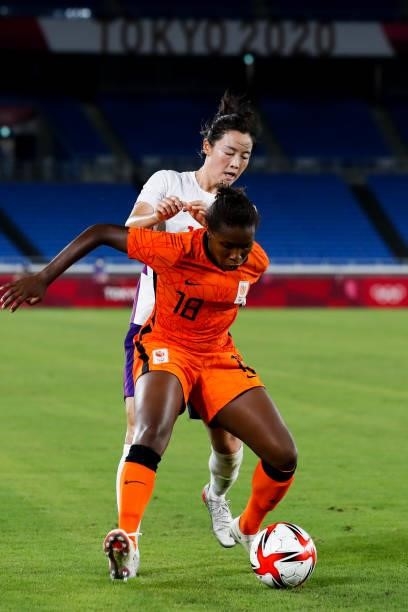 Beerensteyn Lineth of Netherland competes for the ball with Wang Ying of China in the Women's First Round match during the Tokyo 2020 Olympic Games...
