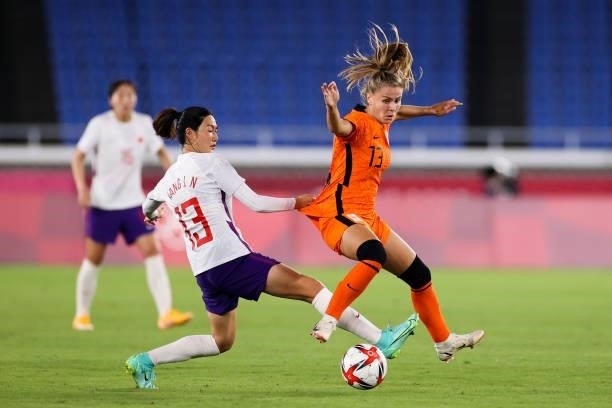 Pelova Victoria of Netherland competes for the ball with Yang Lina of China in the Women's First Round match during the Tokyo 2020 Olympic Games...