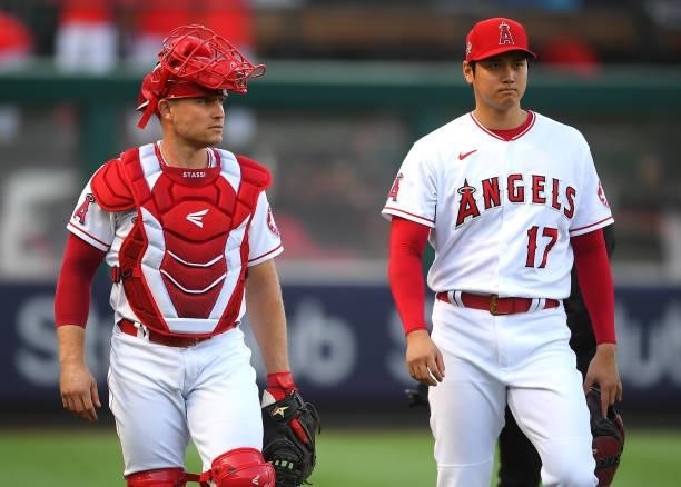 Max Stassi and Shohei Ohtani of the Los Angeles Angels walk in from the bullpen before the game against the Colorado Rockies at Angel Stadium of...