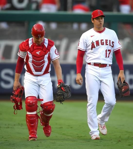 Max Stassi and Shohei Ohtani of the Los Angeles Angels walk in from the bullpen before the game against the Colorado Rockies at Angel Stadium of...