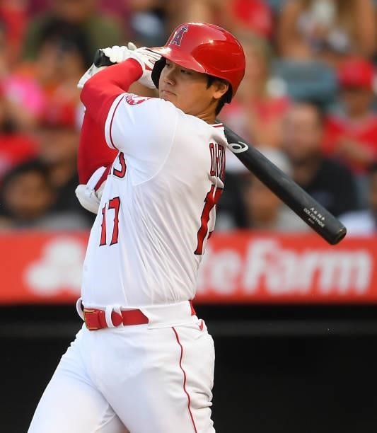 Shohei Ohtani of the Los Angeles Angels hits a single in the first inning of the game against the Colorado Rockies at Angel Stadium of Anaheim on...