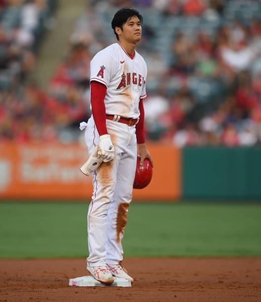 Shohei Ohtani of the Los Angeles Angels stands on the bag after stealing second base in the first inning of the game against the Colorado Rockies at...