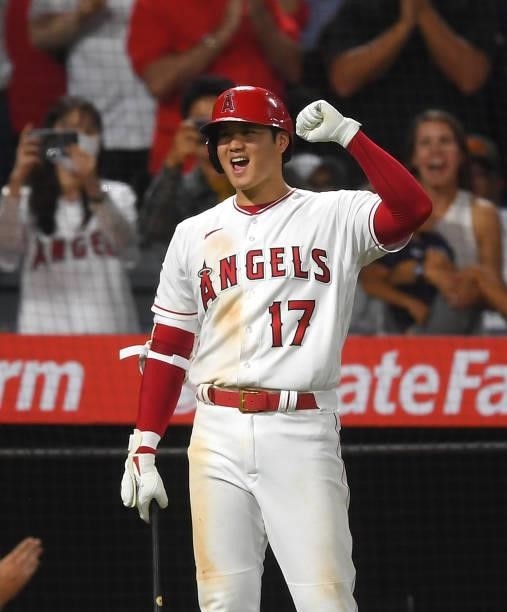 Shohei Ohtani celebrates a home run by Jack Mayfield of the Los Angeles Angels during the game against the Colorado Rockies at Angel Stadium of...