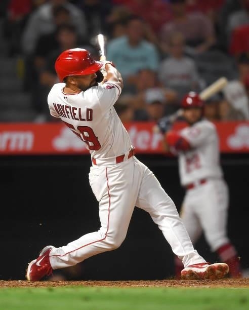 Jack Mayfield of the Los Angeles Angels hits a two run home run in the seventh inning of the game against the Colorado Rockies at Angel Stadium of...