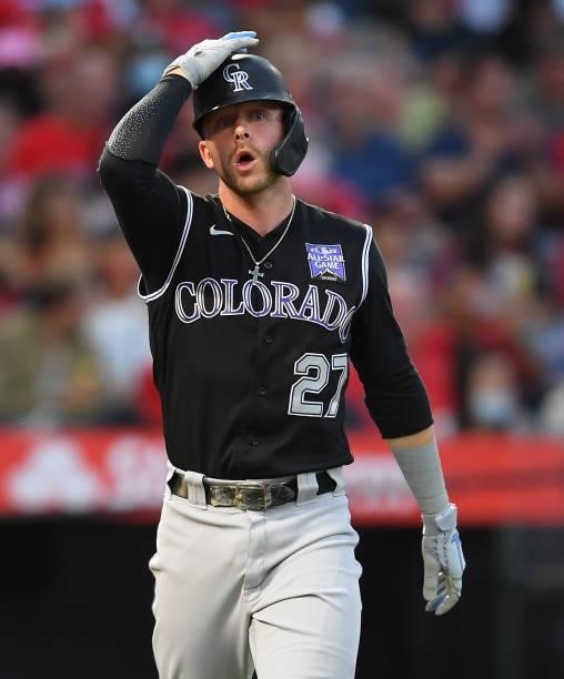 Trevor Story of the Colorado Rockies walks to first after he was with a pitch in the fifth inning of the game at Angel Stadium of Anaheim on July 26,...