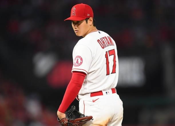 Shohei Ohtani of the Los Angeles Angels looks in for a sign as he pitches in the game against the Colorado Rockies at Angel Stadium of Anaheim on...