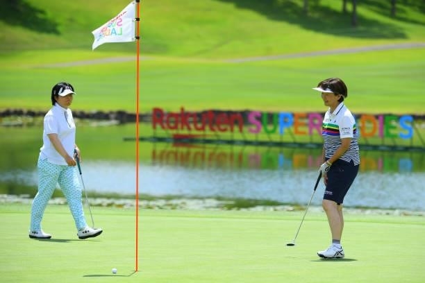 President Hiromi Kobayashi reacts after a putt while Yuri Fudo of Japan watch on the 9th green during the Pro-Am ahead of Rakuten Super Ladies at...