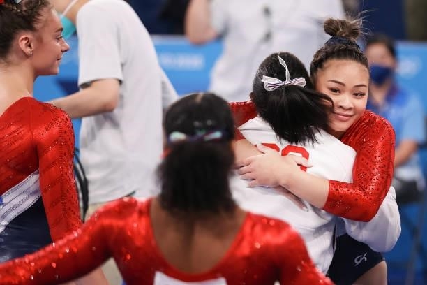 Sunisa Lee of United States of America gets a hug from Simone Biles of United States of America competing on Women's Team Final during the Tokyo 2020...
